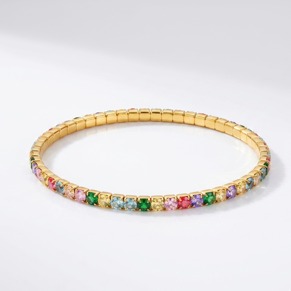Gold bracelet with multicolored gemstones on a white background