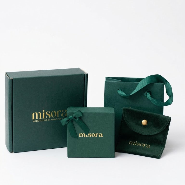 Green jewelry packaging set with 'misora' branding on a white background