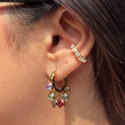 Royal Exotic Huggies Duo multicolour stone earrings styled on an Indian woman.