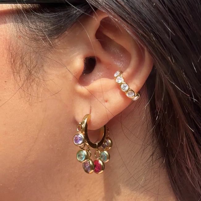 Royal Exotic Huggies Duo multicolour stone earrings styled on an Indian woman.