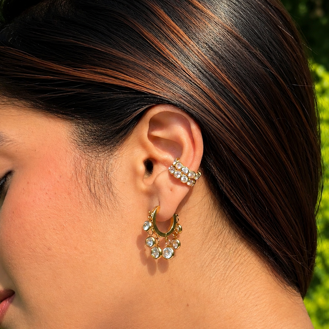 Royal Exotic Huggies Duo white stone earrings styled on an Indian woman.