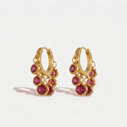 Ruby Rose Set gold huggie earrings with dangling ruby pink stones.