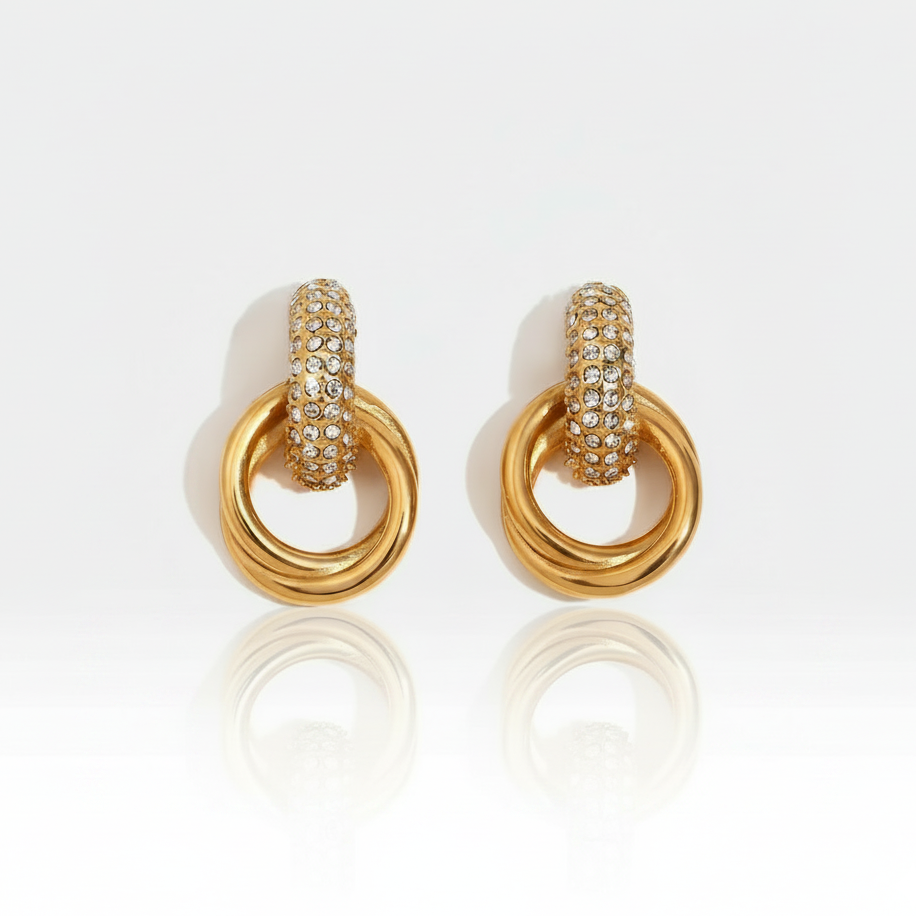 Bella Sparkle Hoops , featuring a crystal-studded top half and smooth 18K gold-plated interlocking rings.