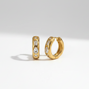 Crystal Charm Mini Hoops displaying a waterproof 18K gold-plated design with mixed-cut baguette and teardrop crystals crafted for daily wear in India.