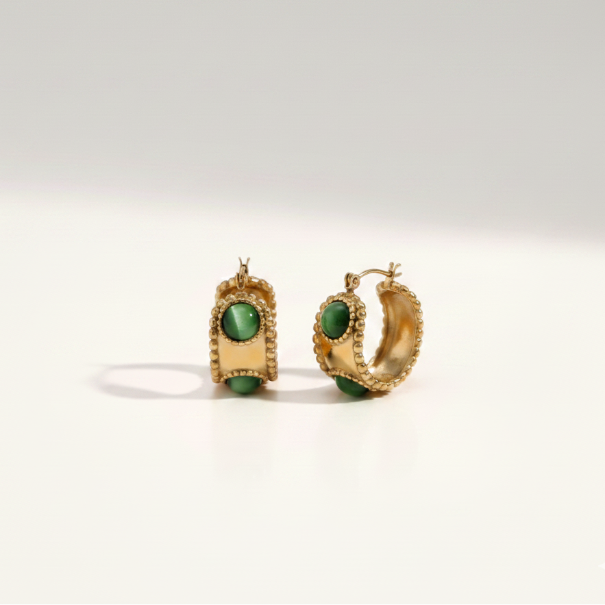 Emerald Studded Hoops highlighting the anti-tarnish gold finish and vibrant green stones perfect for a refined look in India.