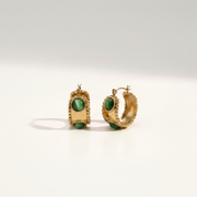Emerald Studded Hoops highlighting the anti-tarnish gold finish and vibrant green stones perfect for a refined look in India.