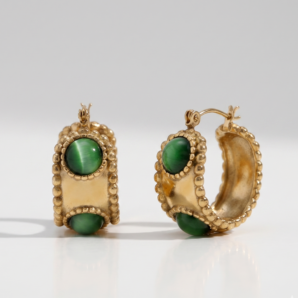 Emerald Studded Hoops displaying a bold 18K gold-plated design with smooth green stones and a waterproof finish crafted for daily wear in India.