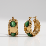 Emerald Studded Hoops displaying a bold 18K gold-plated design with smooth green stones and a waterproof finish crafted for daily wear in India.