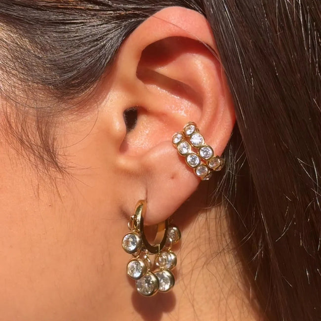 Opulent Elegance Combo styled as a refined ear stack with sparkling crystal huggies and a no-piercing ear cuff