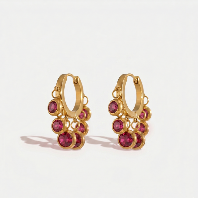 Royal Exotic Huggies Pink featuring vibrant pink gemstone charms in an elegant gold finish