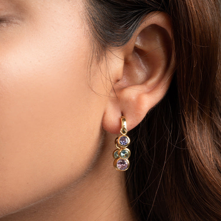 Royal Exotic Huggies multi stone gold earrings – lifestyle photo women jewellery India
