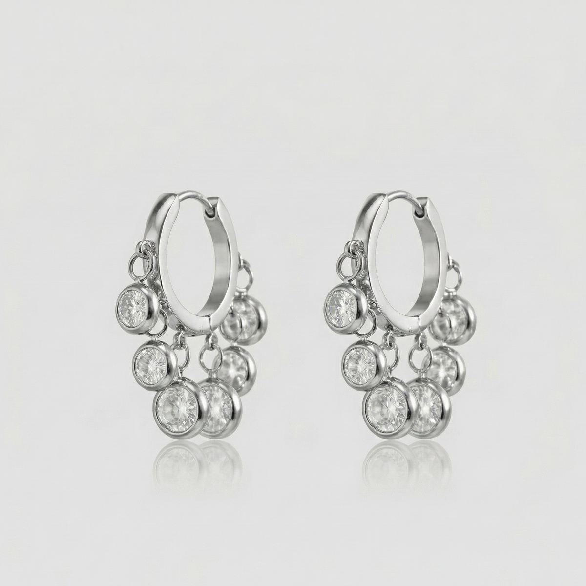 Royal Exotic Huggies Silver with sparkling cubic zirconia charms in a polished silver finish
