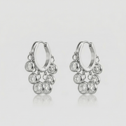 Royal Exotic Huggies Silver with sparkling cubic zirconia charms in a polished silver finish