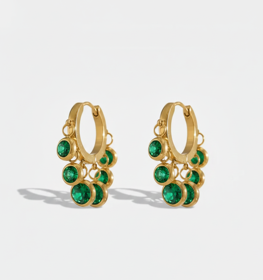 Gold hoop earrings with green gemstones 