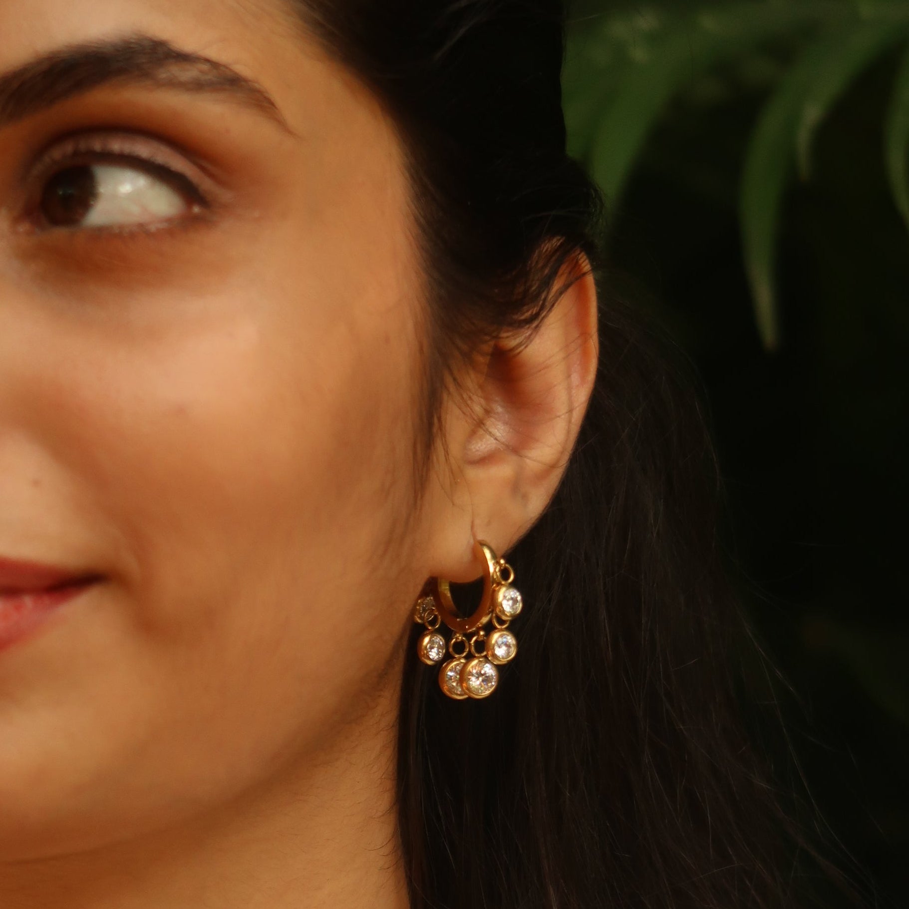 Royal Exotic Huggies white – women wearing gold huggie hoop earrings lifestyle shot India

