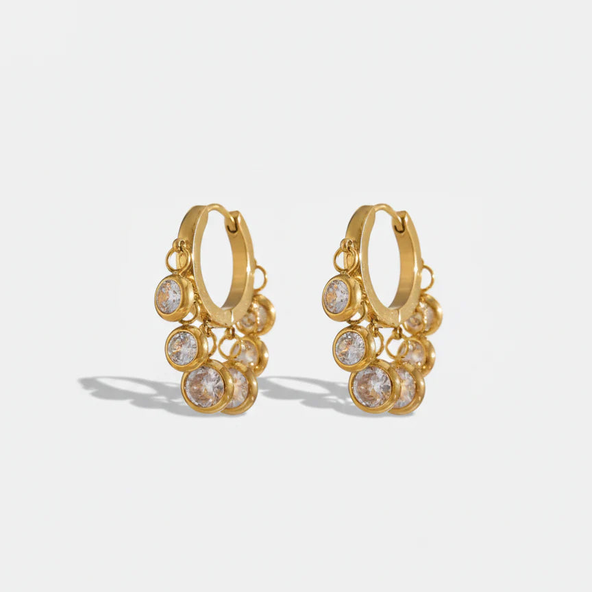 Royal Exotic Huggies Duo white zircon huggie earrings in 18k gold plating.