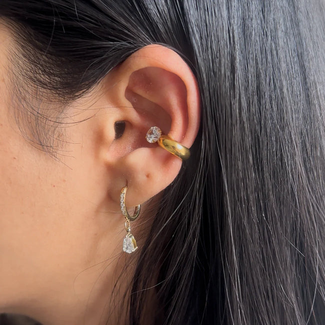 The Daily Stack showcasing a gold Zara Cuff and drop earring for party-ready styling.
